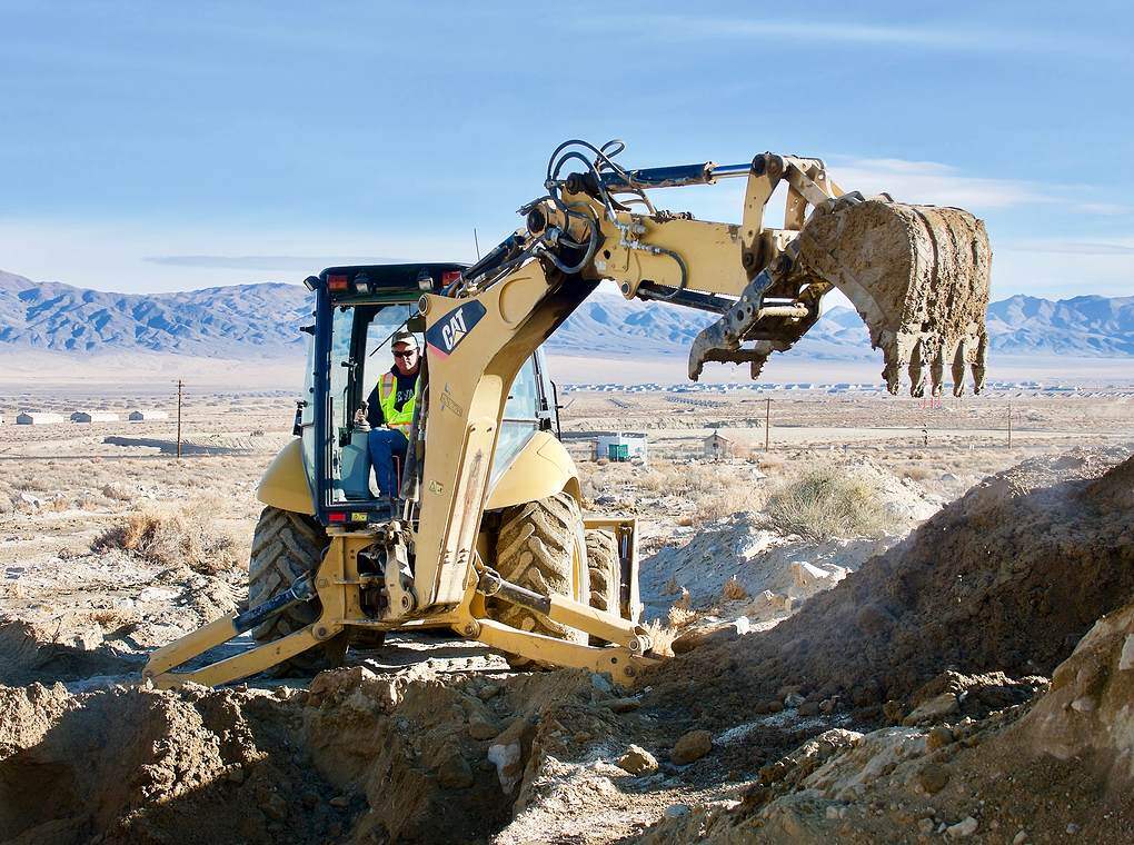 backhoe construction vehicle on rocky terrain